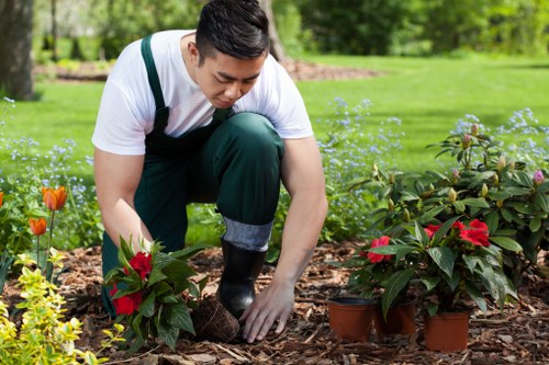 Worker wearing PPE and handling gardening tools